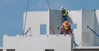 Construction worker are installing the precast concrete wall, or