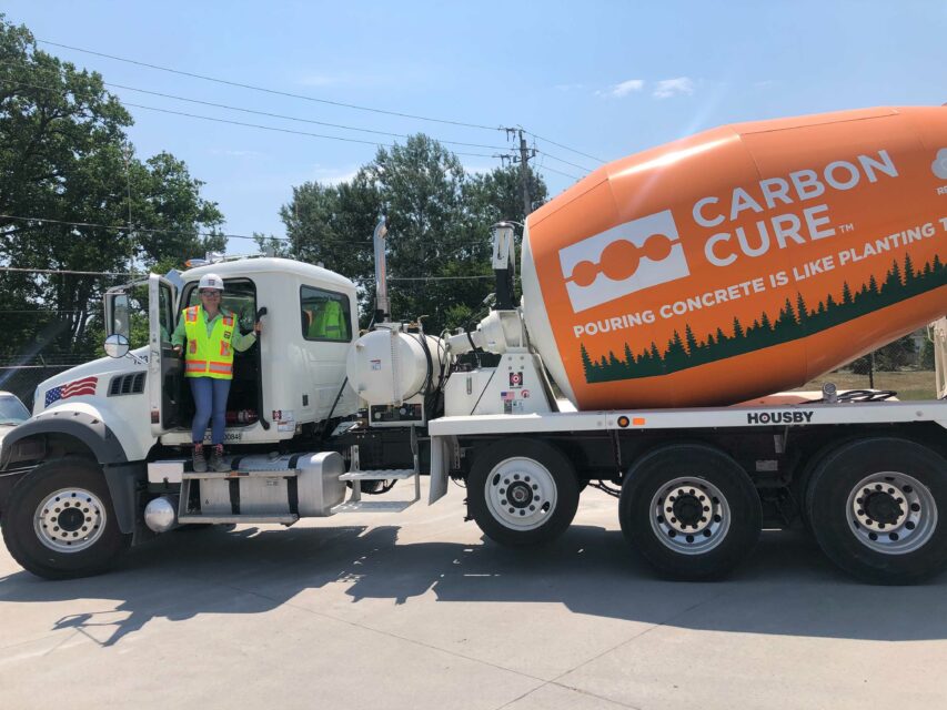 CarbonCure employee with a CarbonCure-branded concrete truck